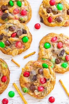 chocolate chip cookies with m & m candy and pretzels on the top one