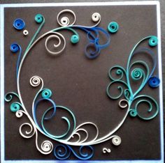 a blue and white card with swirls on the front, and buttons in the middle