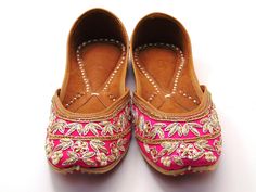 Ethnic Indian/Pakistani style shoes durable and hand stitched with genuine leather sole and leather padded cushion inside. The color of the shoe consists of beautiful pink base with gold and silver beaded embroidery work shaped in flower design around the front top of the shoe all these have a pearl embroidery. These shoes are perfect for any special occasions or for the day-to-day outfits. One of our popular shoes for weddings, and formal events. These shoes are sure to make you beautiful with every outfit you try them on with! See our page for more of our collection! We ship out in a timely matter, wrapped in care for a safe secure trip to your location. Thank you for supporting our small business! Shipped from USA. Sizes available US 6,7,8,9,10. Pink Leather Sole Flats, Pink Slip-on Flats With Leather Sole, Pink Closed Toe Flats With Leather Sole, Traditional Flats With Dori Work For Summer, Traditional Flats With Zari Work For Summer, Traditional Embroidered Slip-on Flats, Festival Embroidered Slip-on Flats, Embroidered Slip-on Flats For Festival, Embroidered Slip-on Flats For Transitional Season