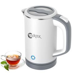 an electric tea kettle next to a cup of tea