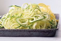 zucchini noodles in a bowl with a fork on the side, ready to be eaten