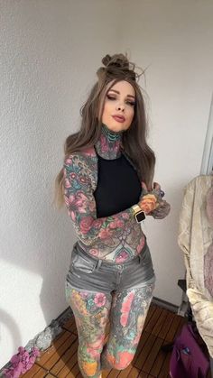 a woman with tattoos on her body and leggings