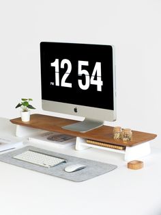 a computer monitor sitting on top of a desk next to a keyboard and mouse pad