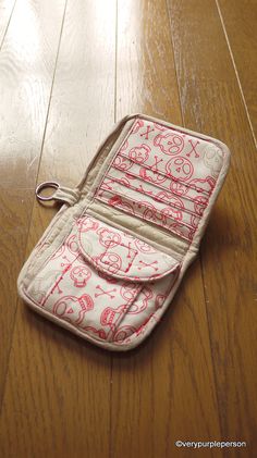 an open purse sitting on top of a wooden floor