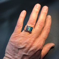 This is our own spin on a timeless classic. We've channel inlaid kyocera opal into our extra heavy mounting (approx. 19 grams). We softened the square just slightly and domed it a bit which gives it a classy look and feel.I like to think of my pieces as heirloom quality, built to last a lifetime.Stone:Lab-Created Kyocera Opal.I also make this ring on other stones:Black Onyx http://www.etsy.com/listing/61398623/mens-heavy-custom-square-black-onyx-ring Lapis http://www.etsy.com/listing/61398979/me Modern Formal Cabochon Opal Ring, Formal Modern Opal Cabochon Ring, Modern Formal Opal Ring With Cabochon, Modern Formal Opal Jewelry, Modern Opal Jewelry For Anniversary, Modern Opal Ring For Anniversary, Modern Collectible Rectangular Jewelry, Blue Star Sapphire, Silver Opal Ring