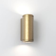 a wall mounted light on the side of a white wall