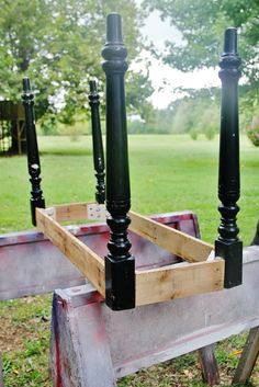 an old wooden cart with black candles in it