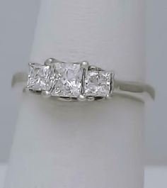 Description Ladies 14k White Gold (not plated or filled) 1.00ct Princess Cut Diamond Three Stone Engagement Ring! GORGEOUS RING! So much nicer in person! Diamond have amazing brilliance and sparkle in person! For diamond color and clarity please see grading below and don't base on the photos as diamonds are hard to capture on camera. Features: FREE appraisal upon request FREE Fedex 2nd day shipping FULLY INSURED Weight: 2 grams Width: 5.4mm Height: 7mm including prongs Diamonds: 3 Princess Cut N Three Stone Engagement Ring, Princess Cut Diamond, Stone Engagement Ring, Three Stone Engagement, Three Stone Engagement Rings, Stone Engagement, Diamond Color, Princess Cut Diamonds, Engagement Wedding