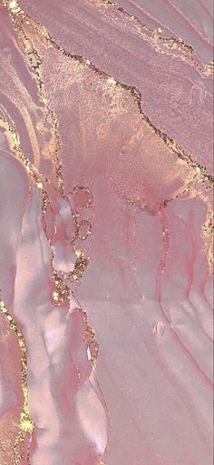 an aerial view of pink and gold paint with the word love spelled in gold glitter