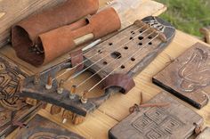 an instrument is sitting on a table with other woodworking tools and materials around it