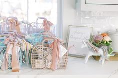 a table topped with baskets filled with baby's breathy pink and blue items