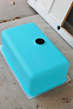 a blue object sitting on the ground next to a door