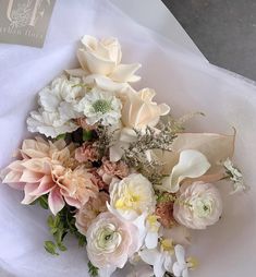 a bouquet of flowers sitting on top of a white sheet