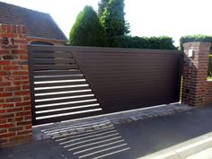 a brick wall and gate in front of a house