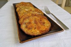 some fried food is on a black plate