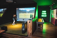 a woman standing in front of a projector screen with a golf ball on it