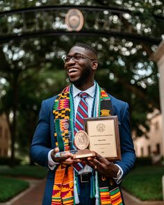 a man in a suit and tie holding an award