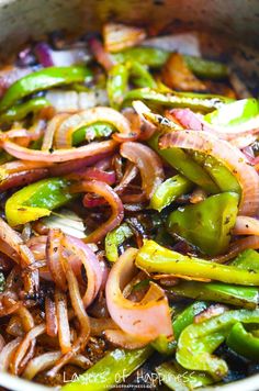 stir fry with onions and green peppers in a pan