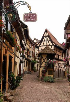 a cobblestone street in an old european town with half - timbered buildings