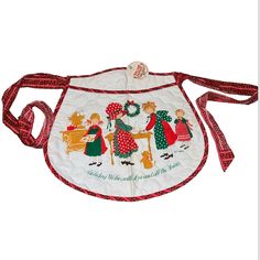 a white apron with red trimmings and an image of children at the kitchen table