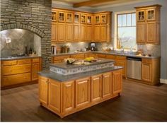 a large kitchen with wooden cabinets and granite counter tops