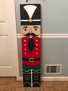 a large wooden nutcracker standing in front of a door