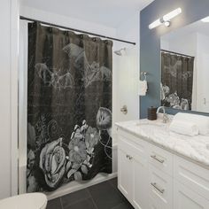 a bathroom with black and white shower curtain