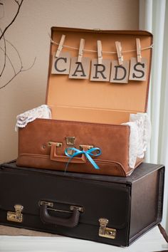 two suitcases are stacked on top of each other with clothes pins attached to them