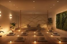 a yoga room with candles lit up on the floor