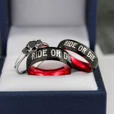 two wedding rings with the words ride or die printed on them in a gift box