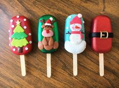 four pops decorated to look like santa clause