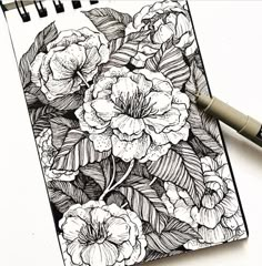 a drawing of flowers on top of a notebook