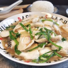 a white bowl filled with food on top of a table