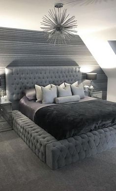 a large bed sitting in the middle of a bedroom