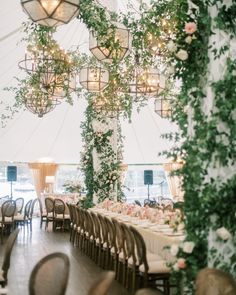 the inside of a tent with tables and chairs set up for a formal dinner party