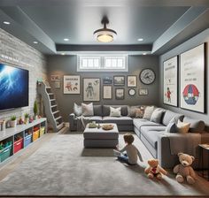 a child sitting on the floor in front of a large couch and television set with multiple pictures on the wall