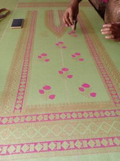 a woman is cutting fabric with scissors on the table