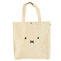 This stylish cotton tote bag will become your most trusted companion for carrying your everyday items. With a classic Miffy face style, and generous size that will fit a laptop and much more, it will be sure to make a statement. Durable and roomy, this bag is the perfect combination of style and practicality. - Color: Cream- Material: Cotton- Interior and exterior slip pockets- Size: approx. 15.75" x 3.94" x 15.35". Strap drop approx. 8".- Official licensed Miffy product Miffy Tote Bag, Miffy Products, Tut Bag, Miffy Stuff, Miffy Bag, Miffy Face, Digital Wardrobe, Face Style, Paddington Bear