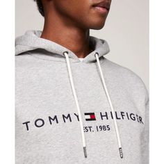 Stay comfortable and stylish with Tommy Hilfiger's Embroidered Logo Hoodie. Made with cotton, this fleece hoodie is designed for total comfort. Featuring the iconic Hilfiger signature logo and a convenient kangaroo pocket, this hoodie is the perfect addition to your wardrobe..Regular Fit: Tommy Hilfiger's Classic Pullover Hoodie made to fit comfortably..Size Medium Chest measures 44-1/2'.Model is wearing a size Medium.Drawstring hoodie for adjustable hood.Kangaroo pocket for added convenience.Classic Tommy Hilfiger embroidered logo.Cotton/polyester.Machine washable.Imported Spring Cotton Logo Sweatshirt, Spring Cotton Sweatshirt With Logo, Cotton Hoodie With Logo Detail Relaxed Fit, Cotton Hoodie With Logo In Relaxed Fit, Hooded Sweatshirt With Logo Detail For Spring, Relaxed Fit Logo Hoodie For Fall, Fall Hoodie With Logo And Relaxed Fit, Fall Hoodie With Logo In Relaxed Fit, Fall Relaxed Fit Hoodie With Logo