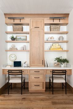 two desks with chairs and shelves in the corner