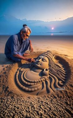 a man is making a sand sculpture on the beach