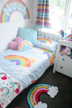 a small child's bedroom with a rainbow theme