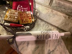 a kitchen utensil with some writing on it sitting on a marble counter top