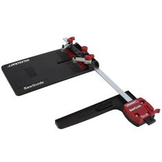 a red and black tool on top of a white surface