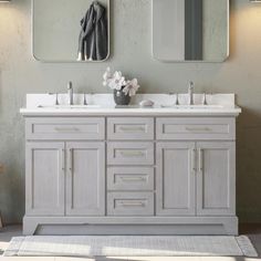 a bathroom vanity with two mirrors above it