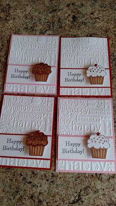 four birthday cards with cupcakes on them sitting on a counter top next to each other