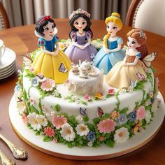 there is a cake decorated with princess figurines on the table