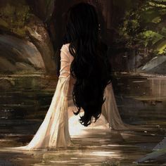 a woman with long black hair standing in water