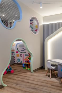 the children's playroom is decorated in pastel colors and features circular mirrors