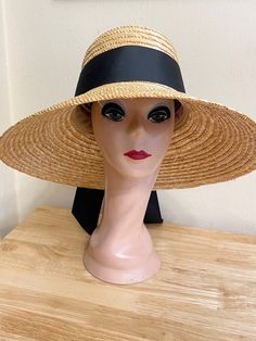 This 5.5 inch bell brim natural wheat straw is made from high-quality Milan braided sewn straw. The sloped brim is 5.5 inches and the crown is 4.5 inches deep. The band is 2 1/2 inch black grosgrain ribbon. The inside band has a sizing cord to adjust the head size. The hat is available in small/medium - Xlg head sizes. The hat has a sizing band inside to perfectly fit your head. The small/medium fits 22 - 22 3/4 inch head size. The large will fit 59cm 22 3/4- 23 1/4-inch head size and the extra-large hat is 61cm and will fit 23 - 24  inch head size, 7 1/2 fitted head size. Handwoven Curved Brim Straw Hat For Kentucky Derby, Straw Visor Sun Hat For Kentucky Derby, Woven Straw Hat With Curved Brim, Handwoven Wide Brim Straw Hat For Kentucky Derby, Handwoven Straw Boater Hat With Wide Brim, Handwoven Wide Brim Straw Boater Hat, Woven Straw Hat With Curved Brim For Kentucky Derby, Natural Woven Straw Hat For Kentucky Derby, Adjustable Handwoven Straw Hat For Kentucky Derby